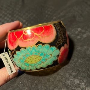 Gorgeous gold inlayed Indian cuff bracelet trimed in gold toned accents.